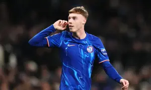 Młody piłkarz Cole Palmer w niebieskiej koszulce Chelsea z charakterystycznym wzorem, gestykuluje podczas meczu.