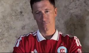 Robert Lewandowski w czerwonej koszulce z białymi pasami. W jakich klubach grał Lewandowski? Lech Poznań, Borussia Dortmund, Bayern Monachium, FC Barcelona.