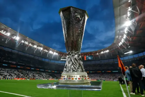Trofeum Ligi Europy na tle stadionu, symbol walki o awans w fazie play-off.