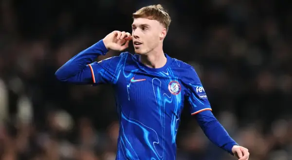 Młody piłkarz Cole Palmer w niebieskiej koszulce Chelsea z charakterystycznym wzorem, gestykuluje podczas meczu.