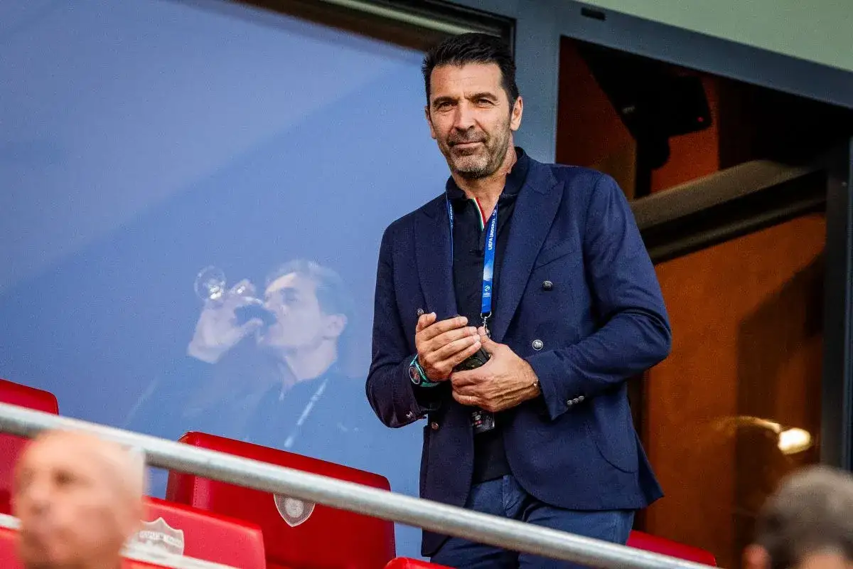 Gianluigi Buffon, jeden z najlepszych włoskich bramkarzy, w eleganckim garniturze obserwuje mecz.